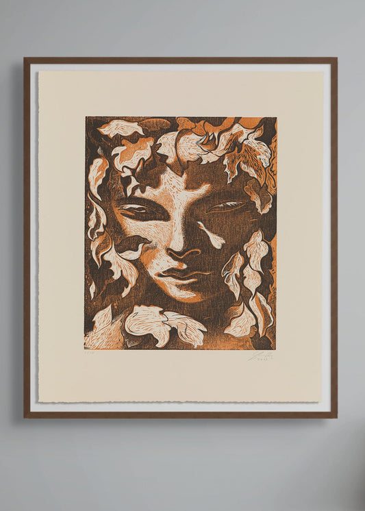 Framed artwork by Dennis Scholl of a face with floral elements on a gray wall.