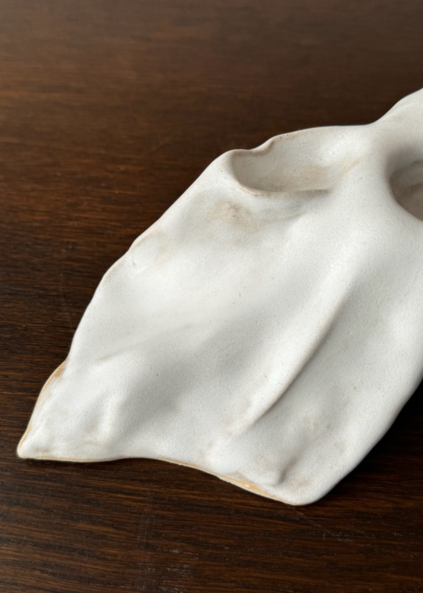 Detail of a candleholder artwork with white glaze designed by Aline Schwörer