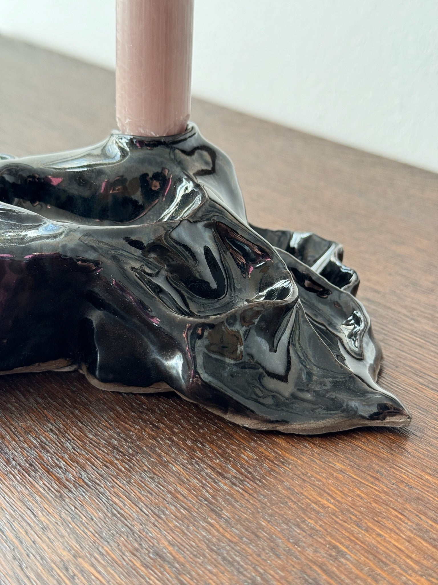 Detail of a black candleholder with a candle