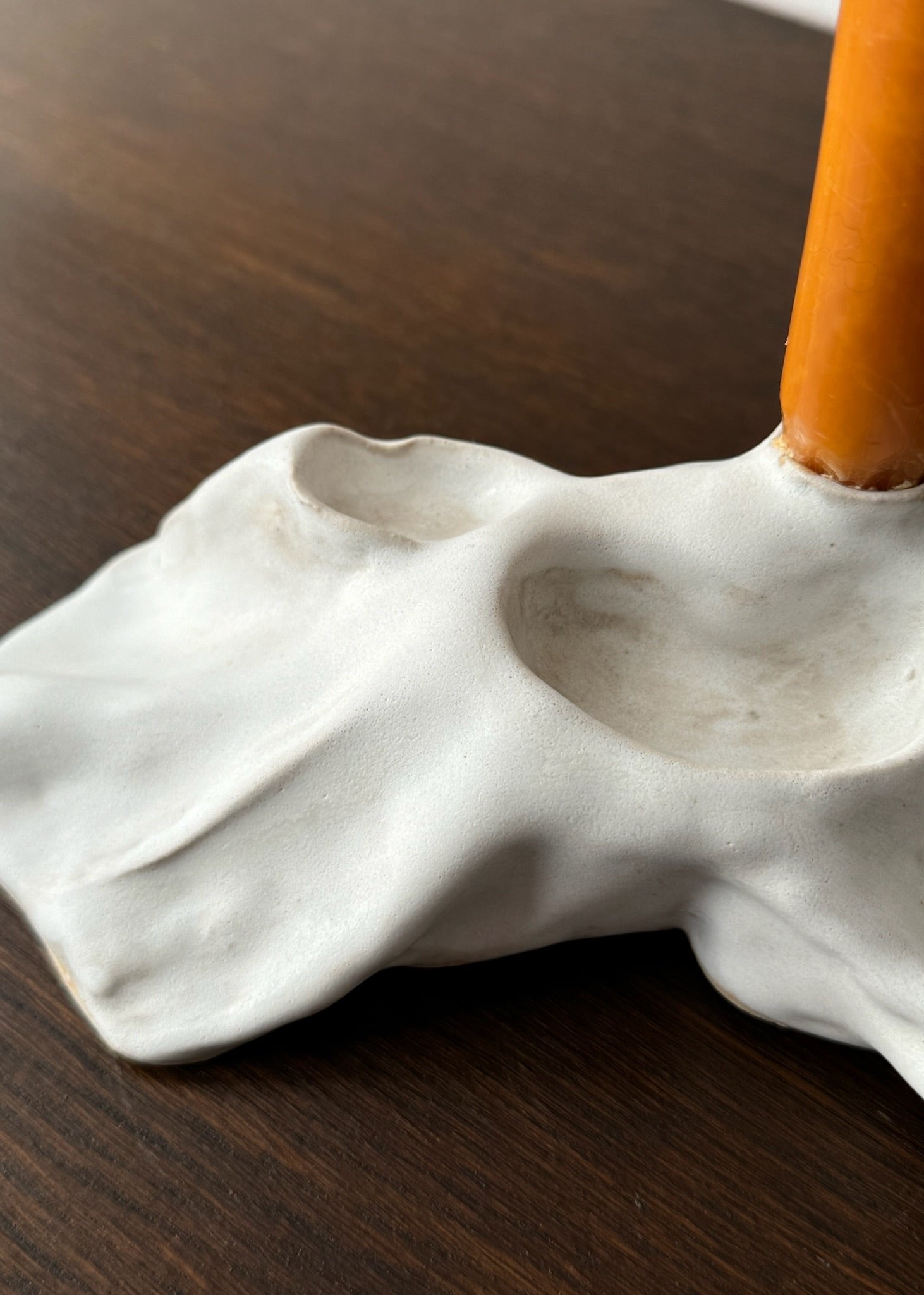 Detail of a candleholder artwork with white glaze designed by Aline Schwörer