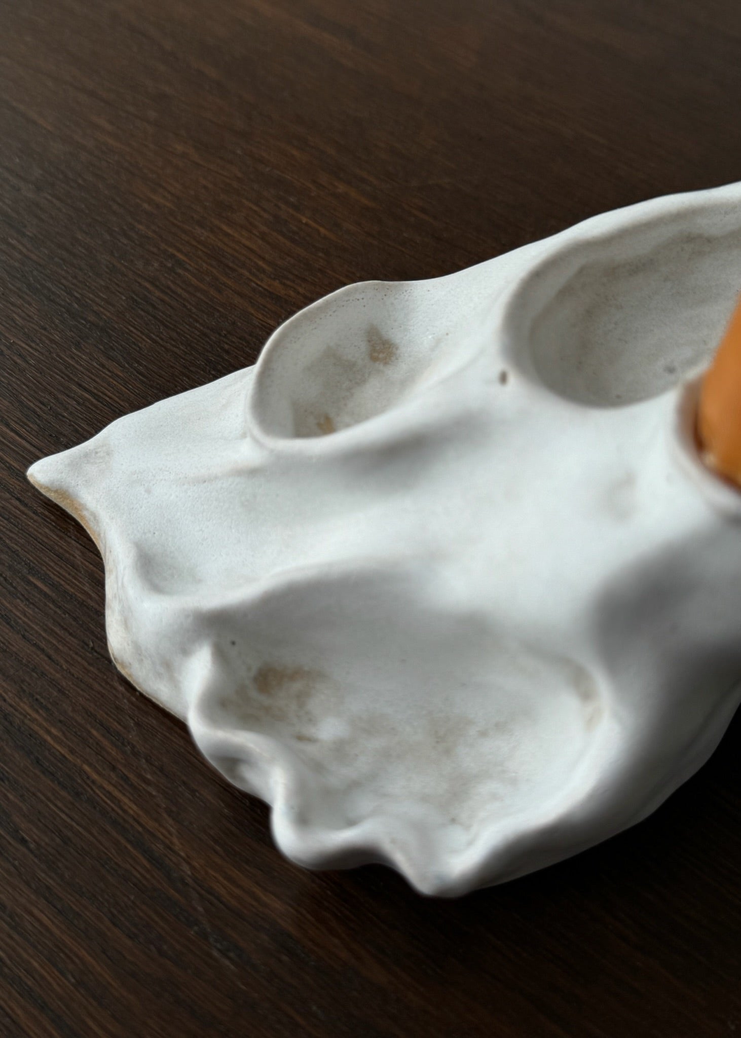 Detail of a candleholder artwork with white glaze designed by Aline Schwörer