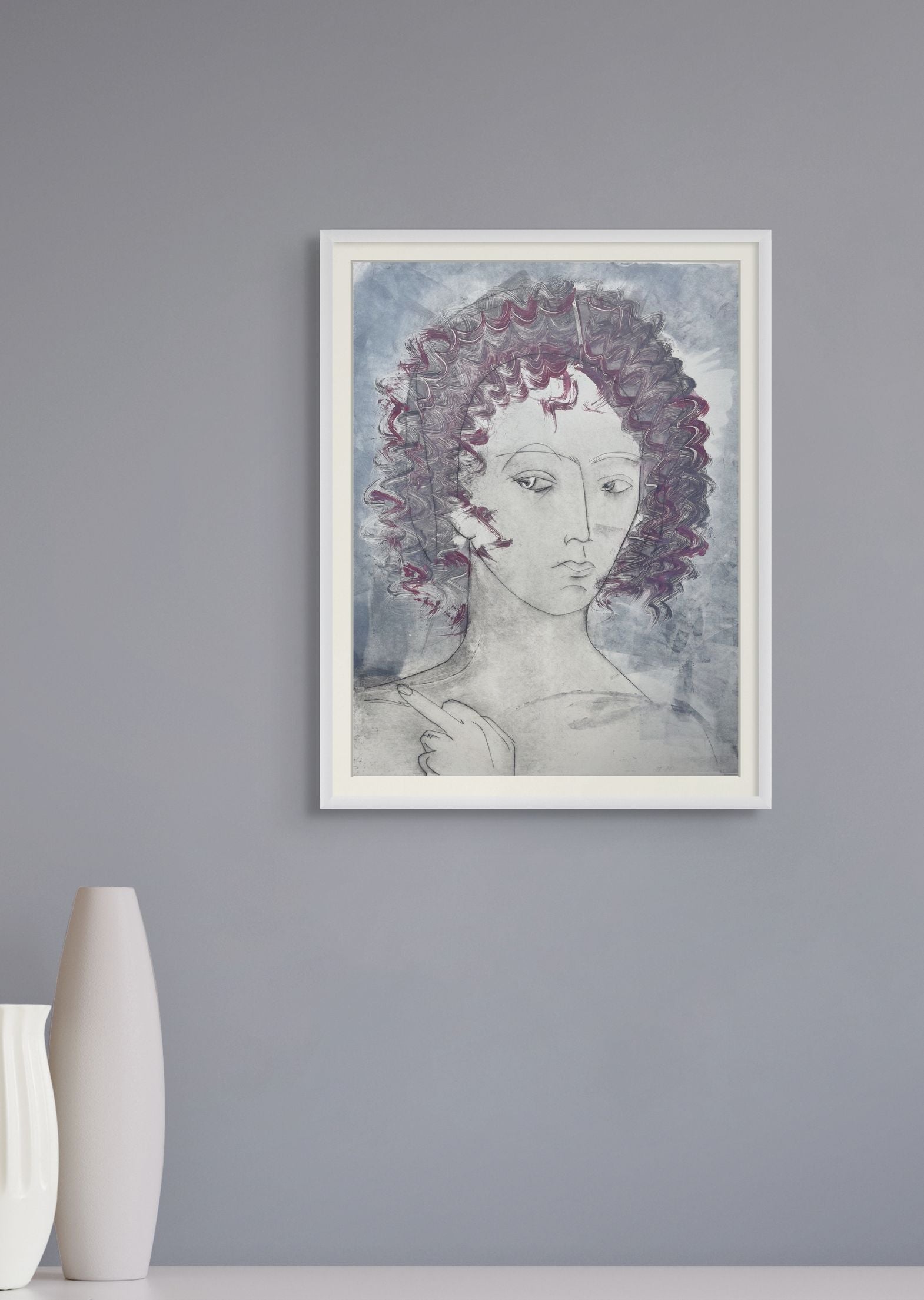Framed artwork of a woman with purple hair on a gray wall.