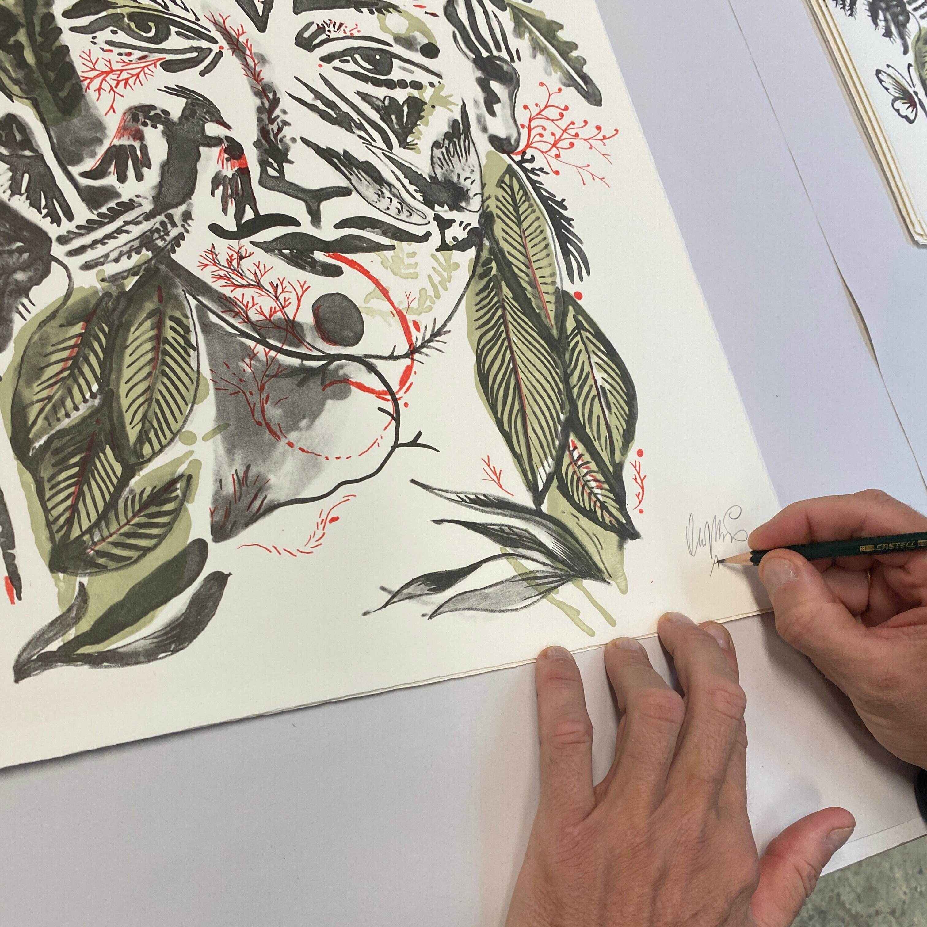 Zoom in on the hands of Olaf Hajek signing his lithograph for FRIDAY BIRD