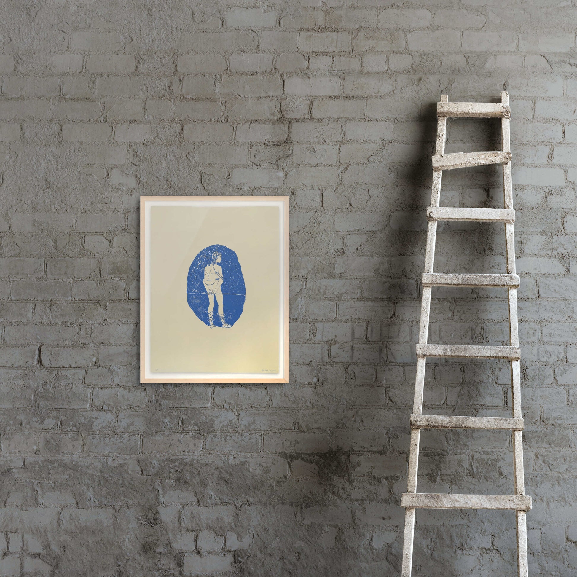 Framed print by Peter Böhnisch on a gray brick wall next to a wooden ladder