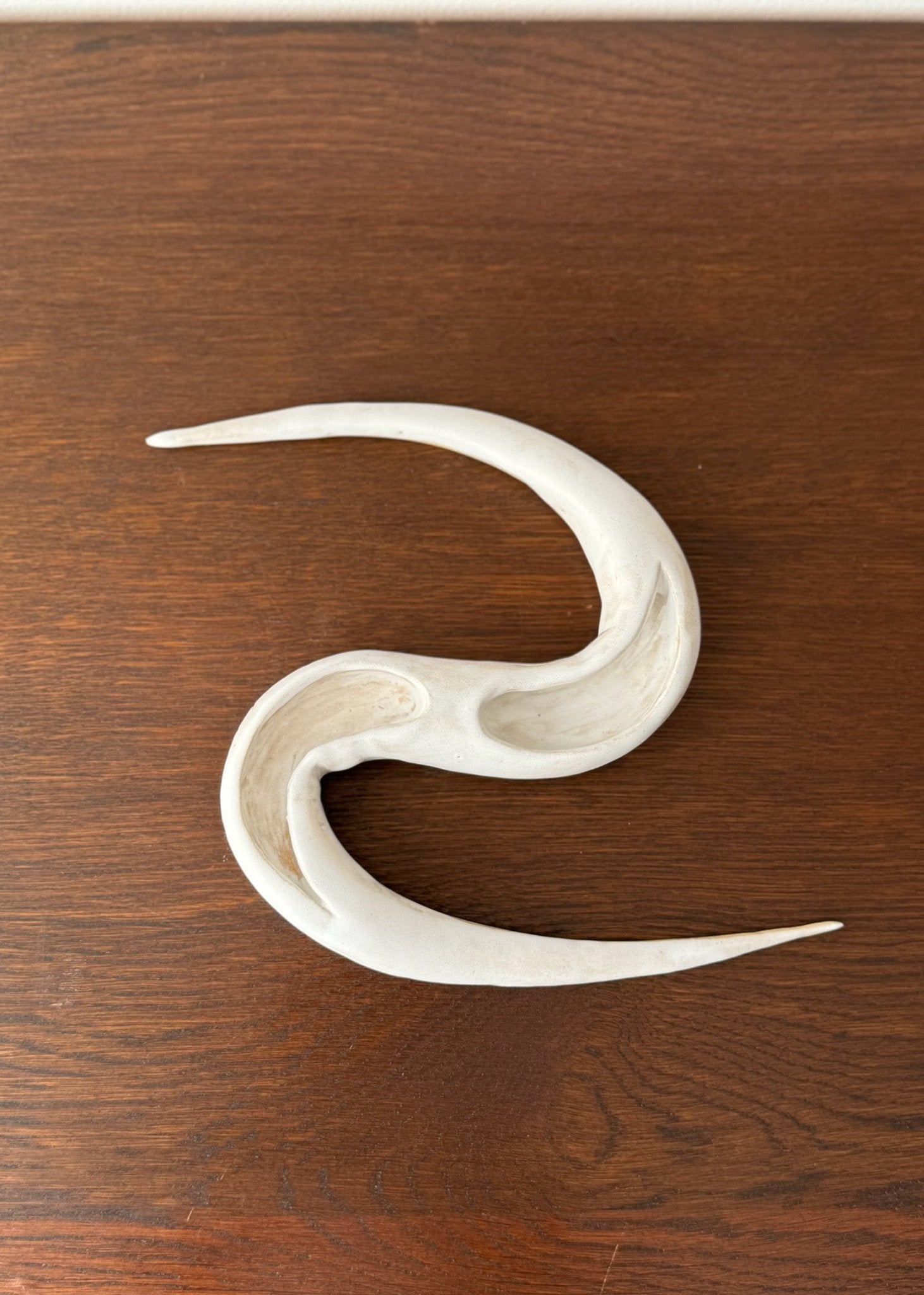 White ceramic bowl resembling a snake