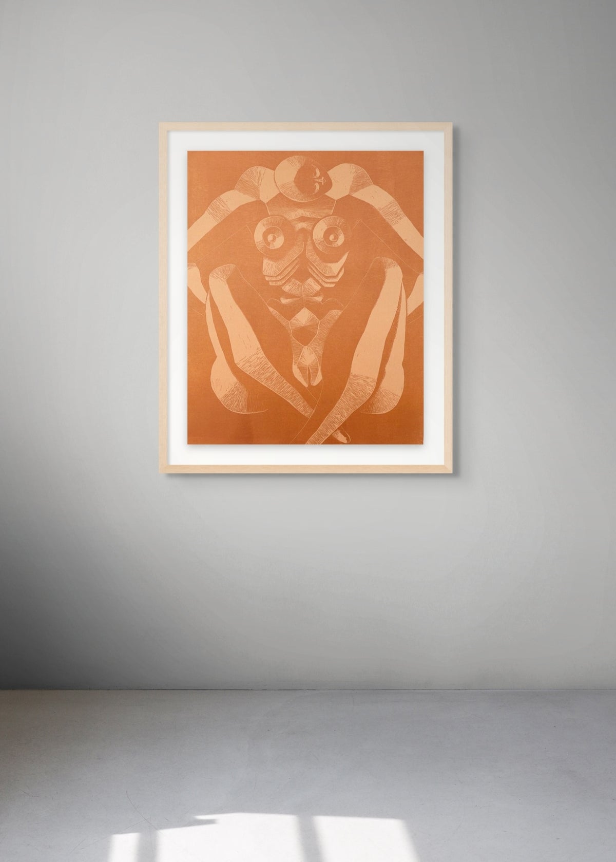 Framed woodcut with a sitting female figure in a room