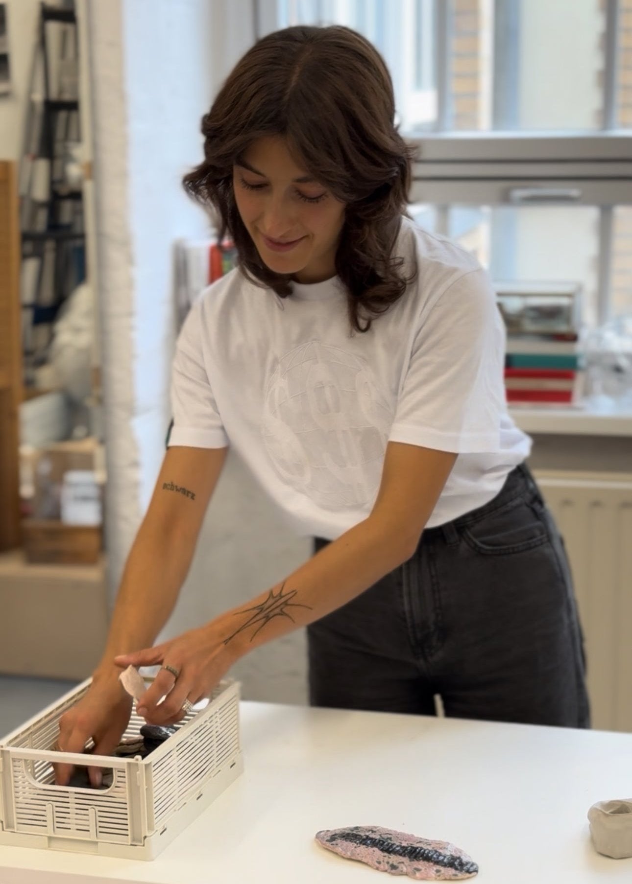 Artist Aline Schwoerer in her studio, arranging cermamic glaze samples