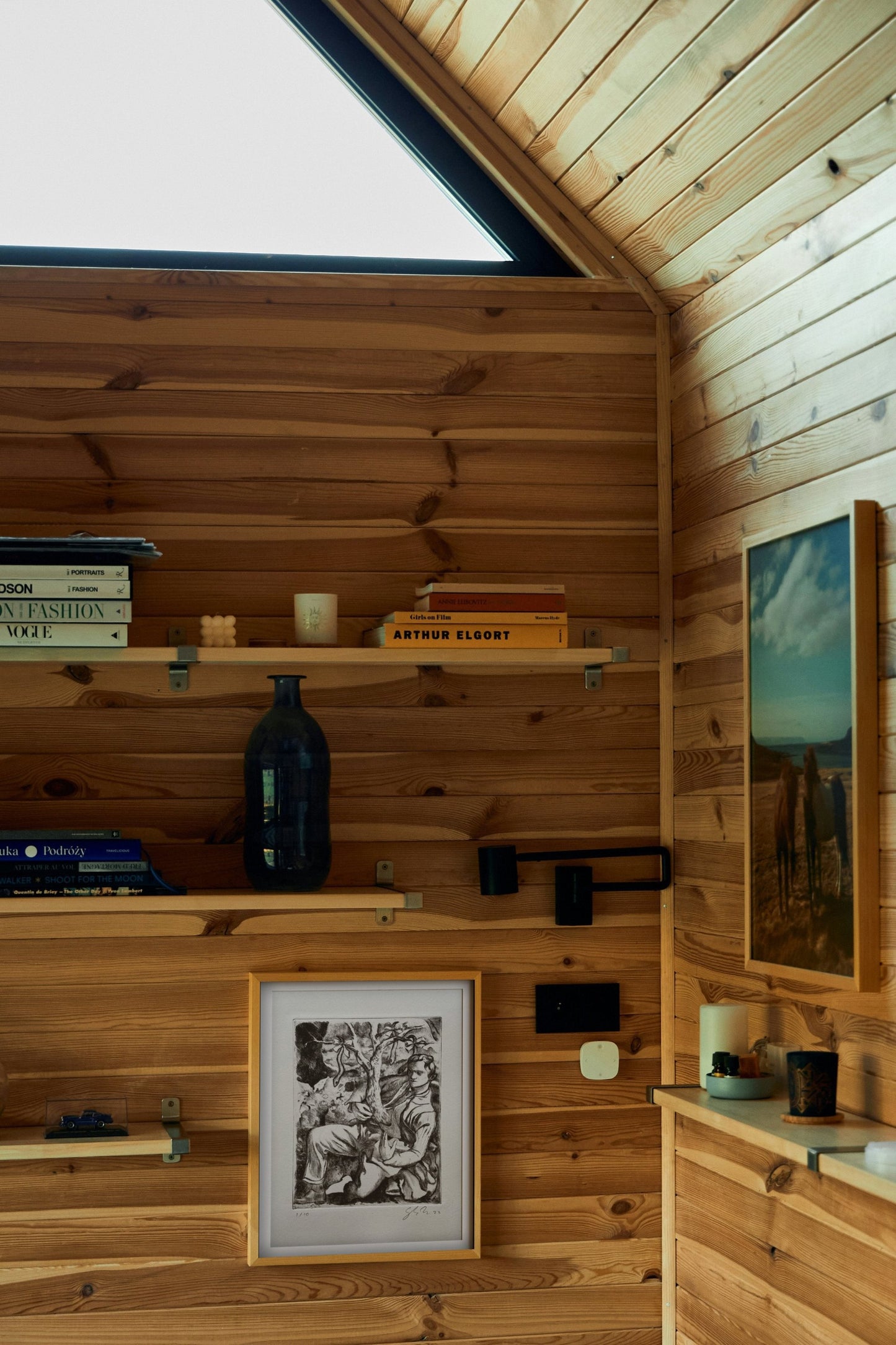 Black and white etching in a wooden cabin with books