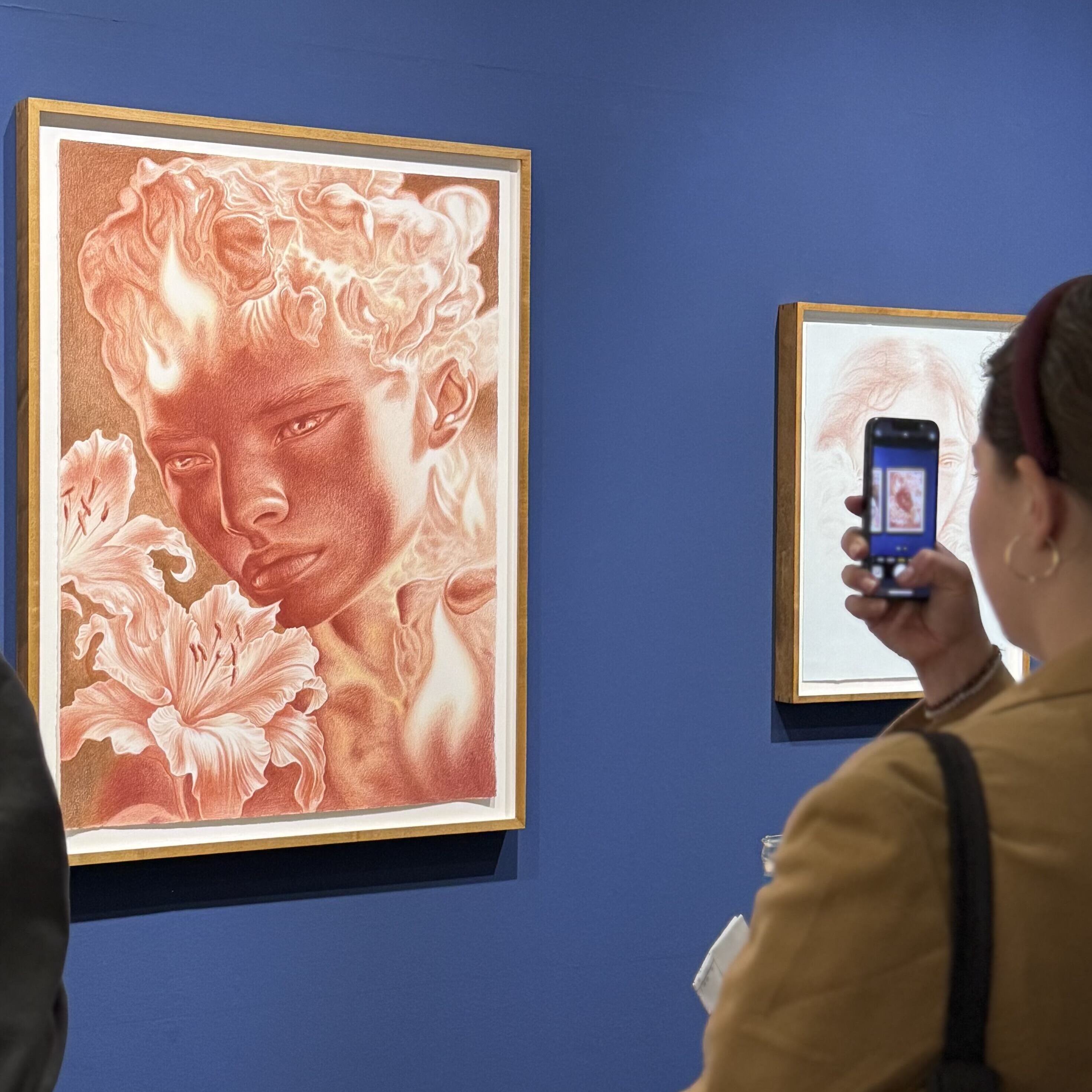 Person taking a photo of an artwork by Dennis Scholl