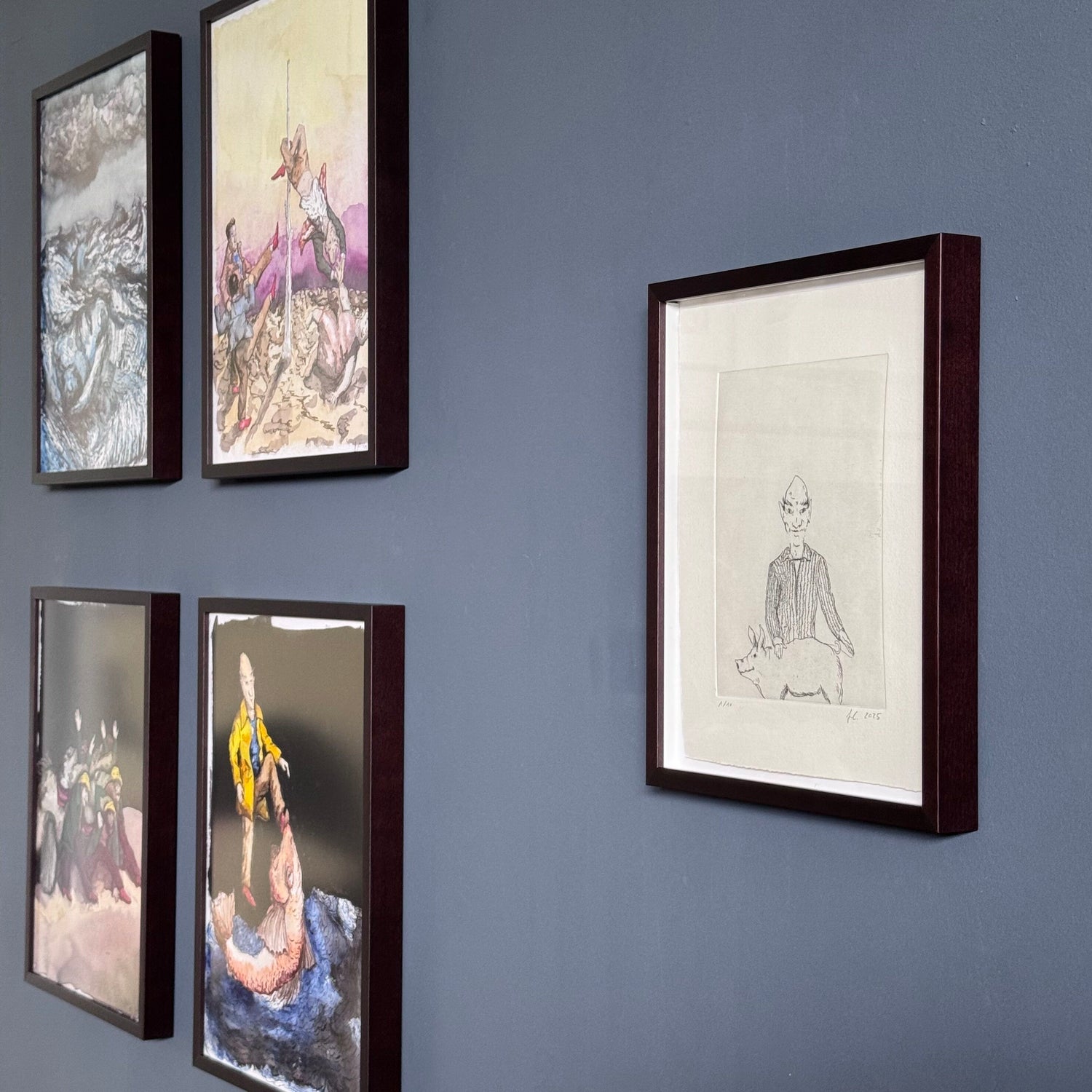 Framed artworks by Finn Carstens on a grey wall