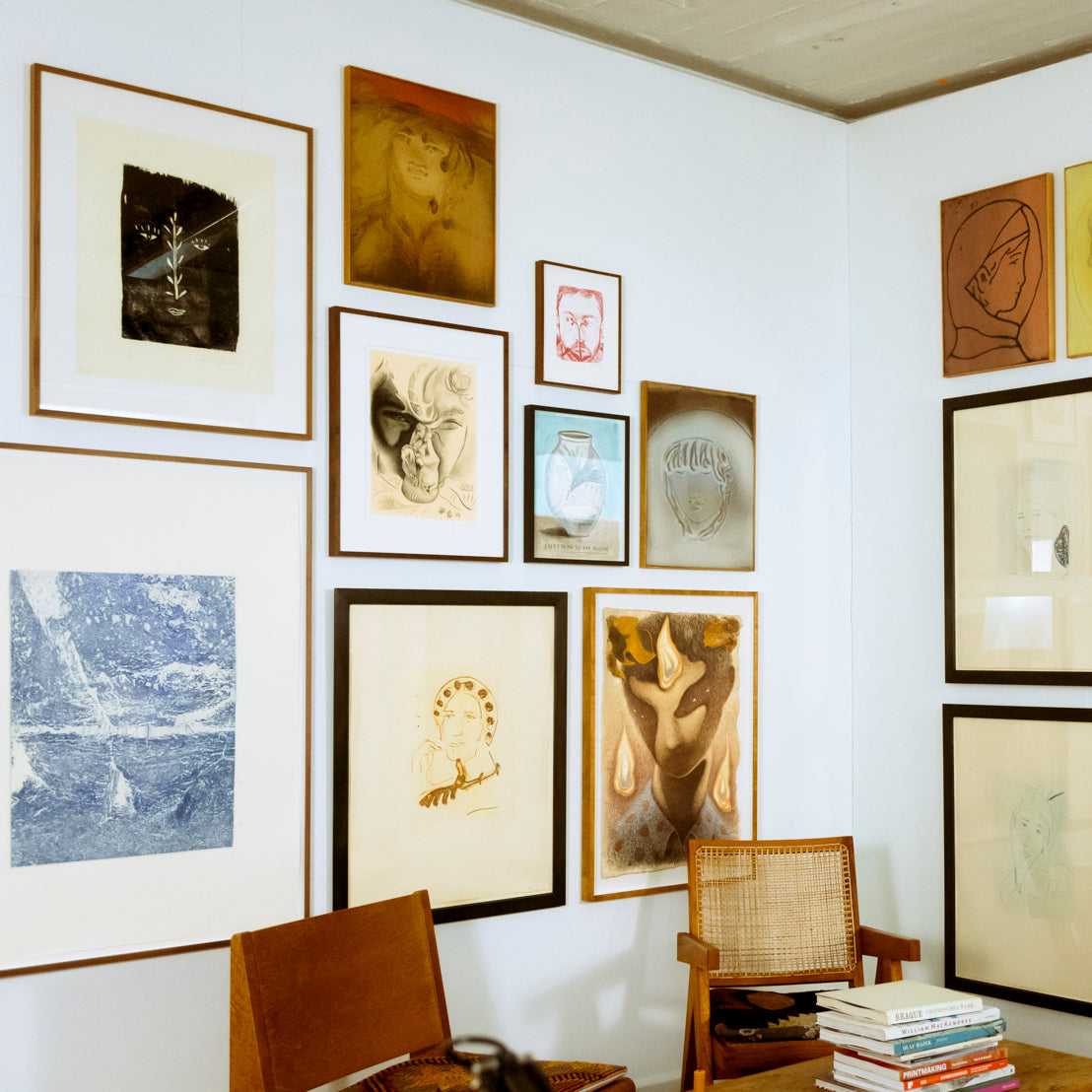 Wall with various framed artworks at Friday Bird Gallery