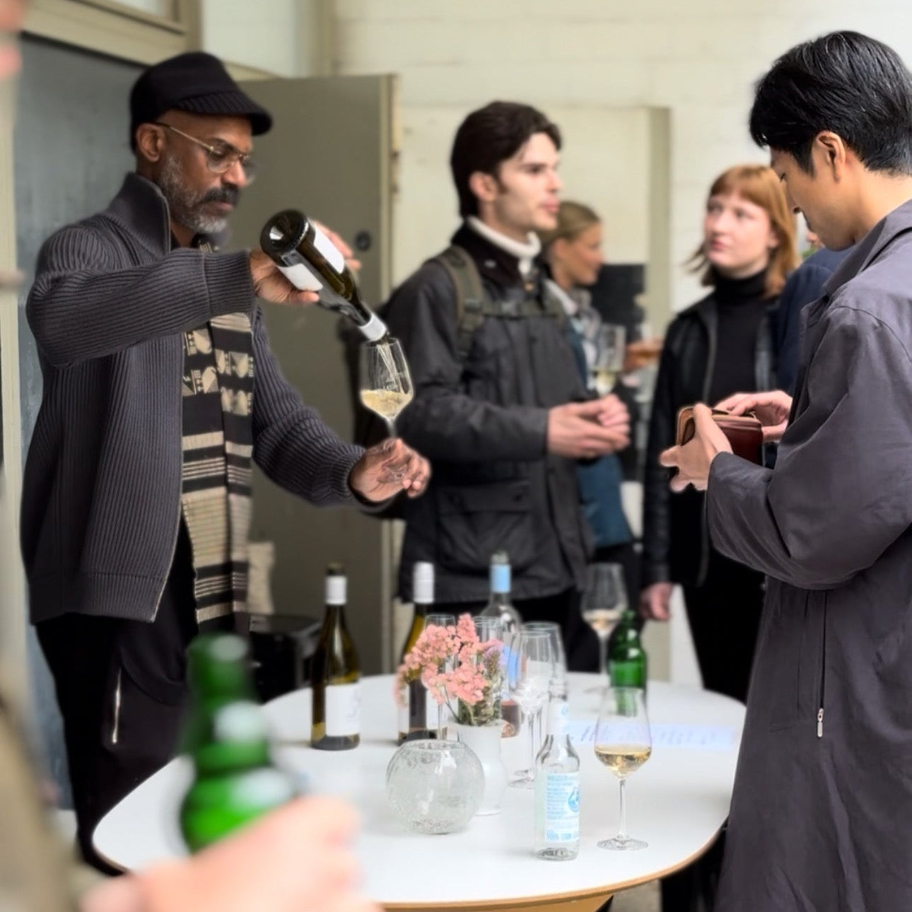 People drinking wine in front of FRIDAY BIRD Gallery