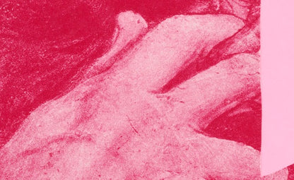 Close-up of a textured pink surface with a detail of a hand
