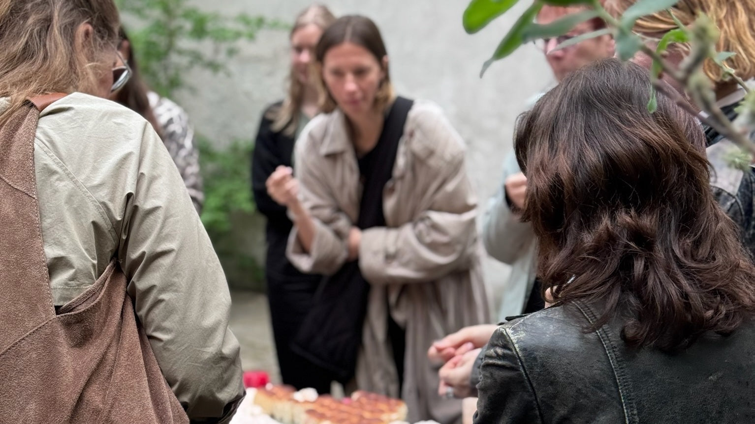Group of people gathered around a table with food