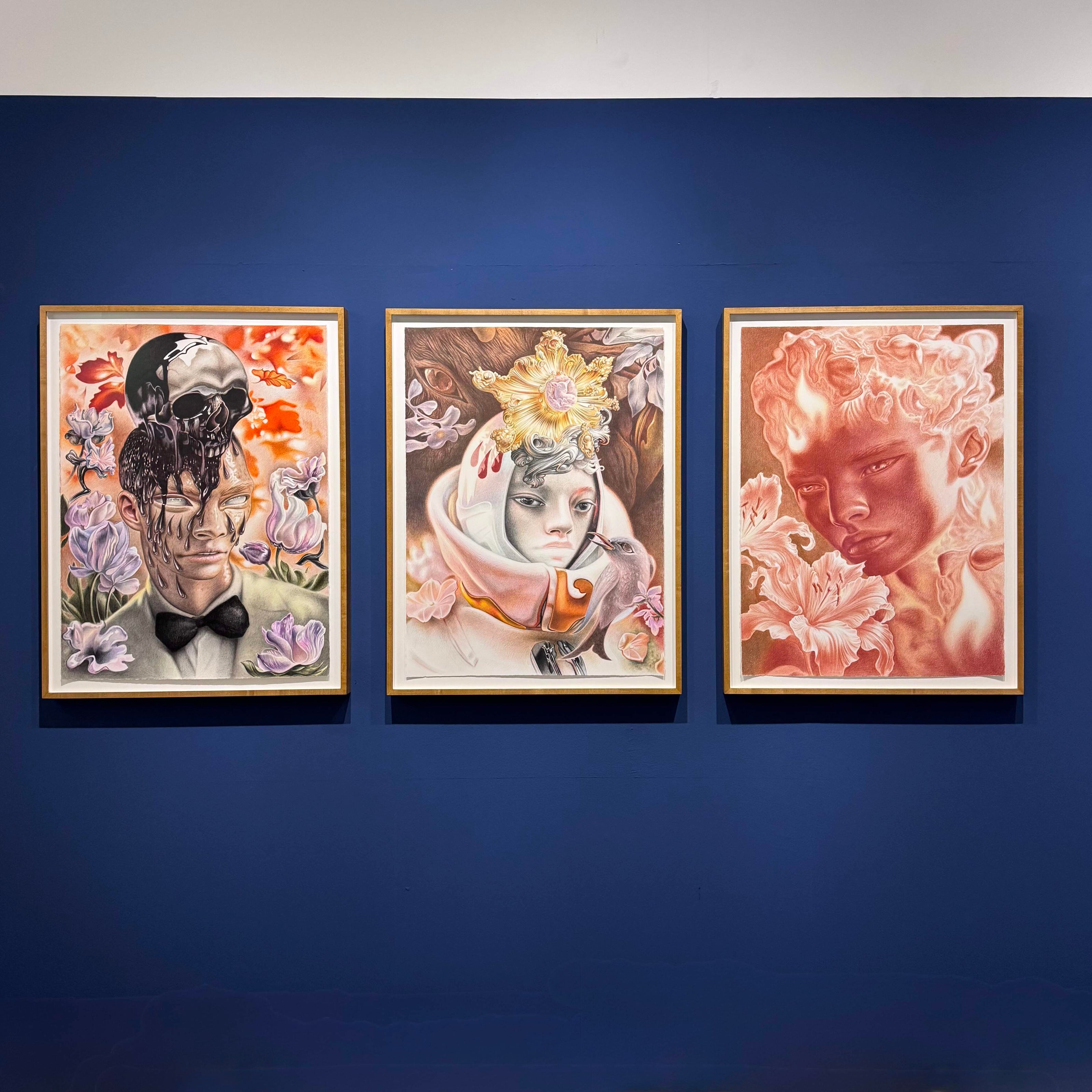 Three framed drawings by Dennis Scholl on a blue wall