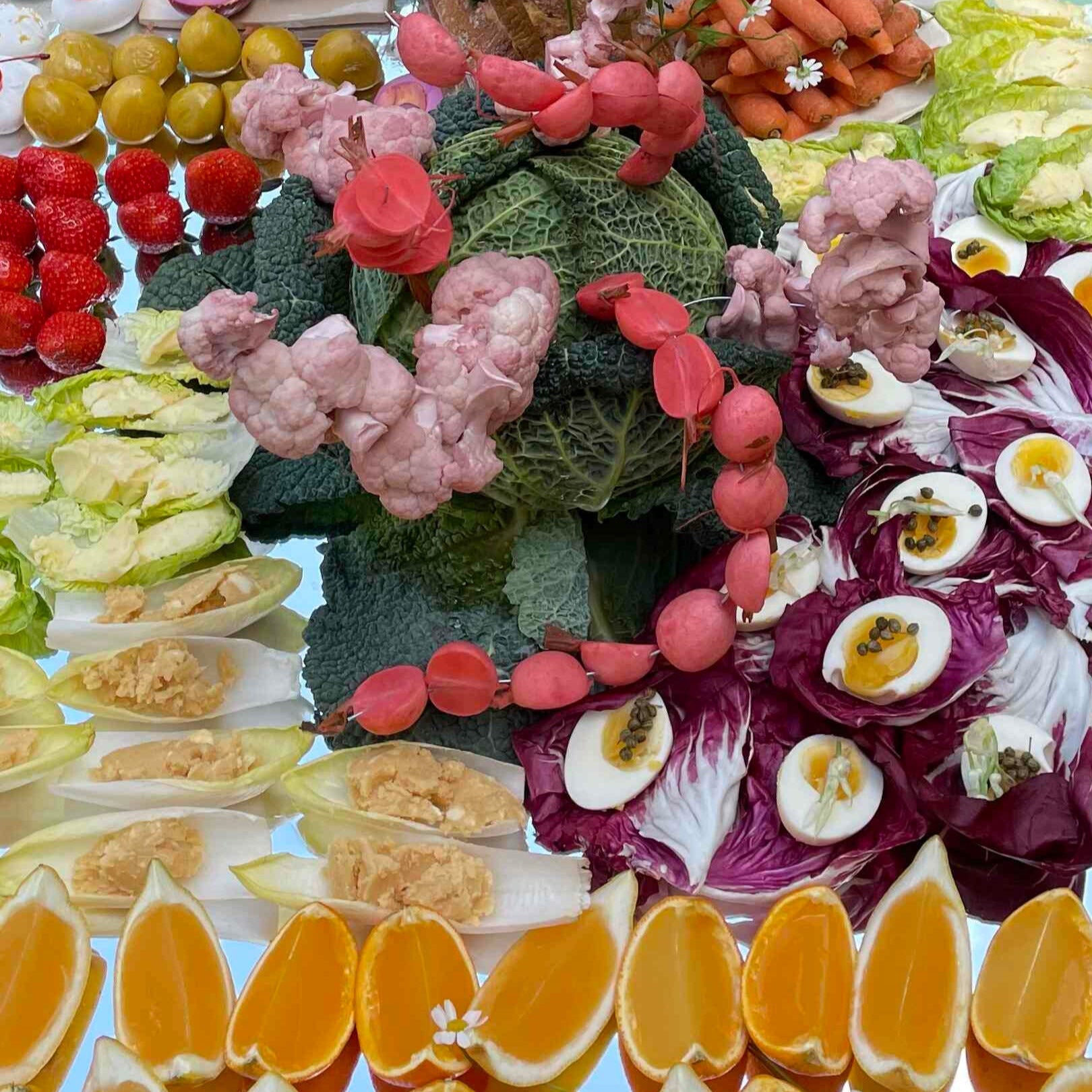 Detail of edible Sculpture by Melina Matzanke showing  oranges, eggs, radisches and other fruit and vegetables.