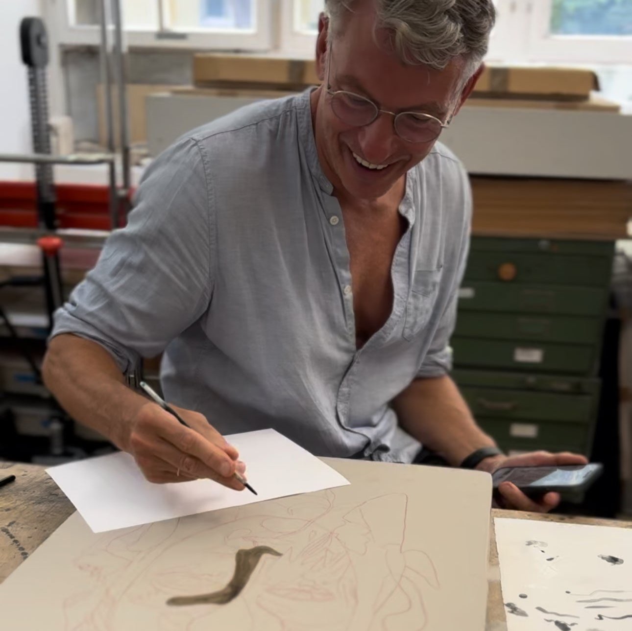 Photograph of Olaf Hajek working on the lithographic stone for his project for FRIDAY BIRD