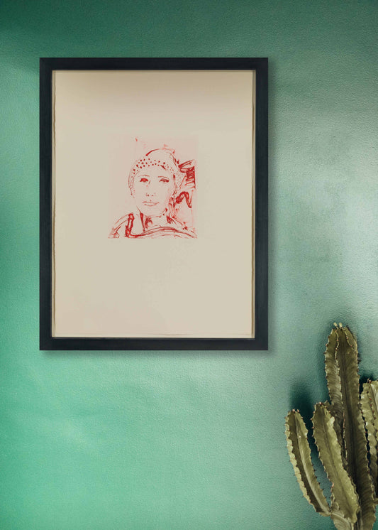 Framed artwork by Thomas Schütte on a green wall with a cactus plant.