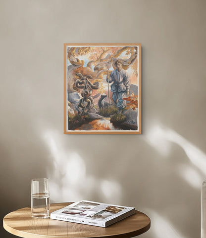 Framed artwork on a wall with a glass of water and book on a table below.