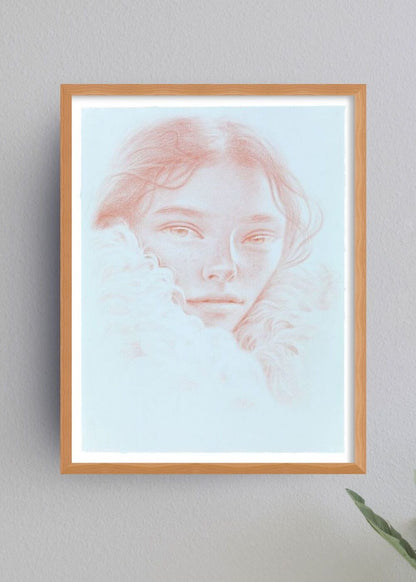 Framed artwork of a woman's portrait on a light gray wall.