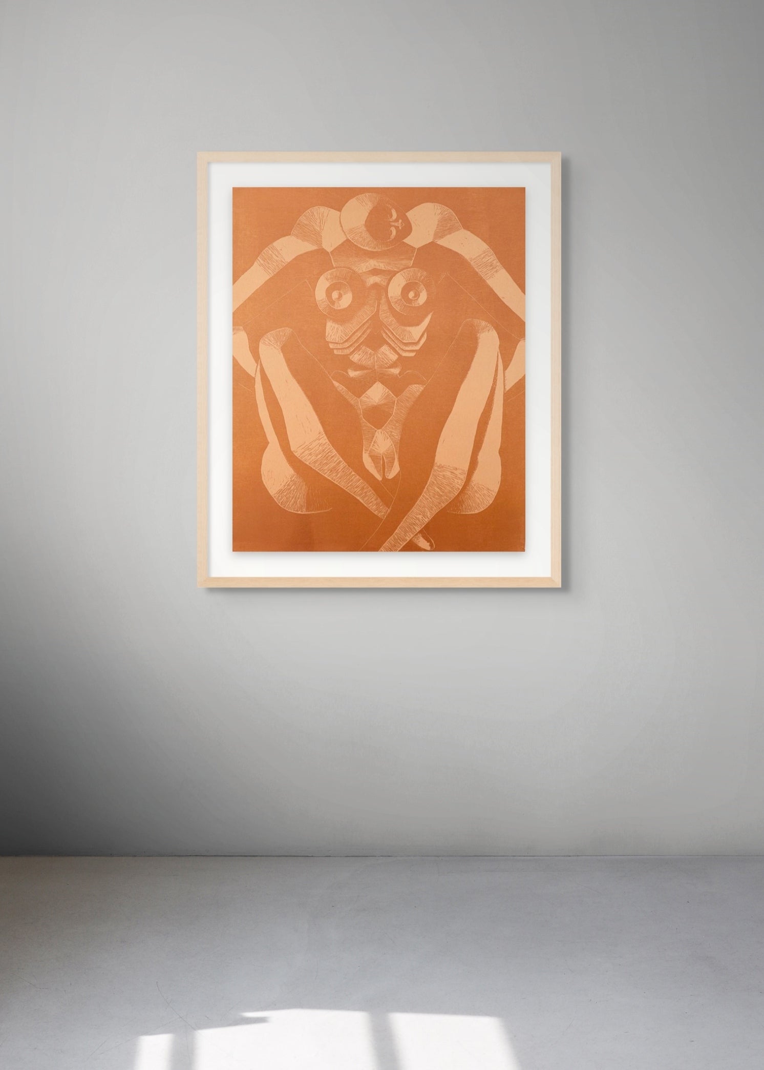 Framed woodcut with a sitting female figure in a room